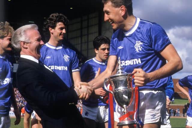 Terry Butcher is congratulated by Rangers chairman David Holmes after receiving the Scottish Premier Division trophy at Ibrox in 1987. (Photo by SNS Group).