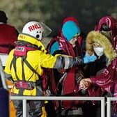 A group of people are brought in to Dover, Kent, by the RNLI, following a small boat incident in the Channel after 27 people died in the worst-recorded migrant tragedy in the Channel. Picture: Press Association