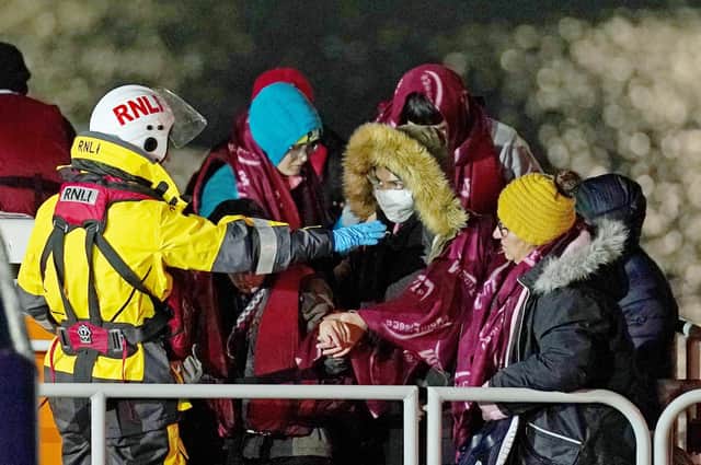 A group of people are brought in to Dover, Kent, by the RNLI, following a small boat incident in the Channel after 27 people died in the worst-recorded migrant tragedy in the Channel. Picture: Press Association