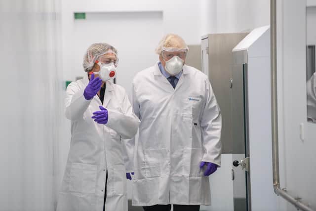 Britain's Prime Minister Boris Johnson (right) talks with site director Frances Muir (left) during a visit to the French biotechnology laboratory Valneva in Livingston. Picture: Wattie Cheung/POOL/AFP via Getty Images