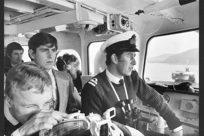 Prince Charles captains the HMS Bronington in Scottish waters as his brother Prince Andrew looks on.