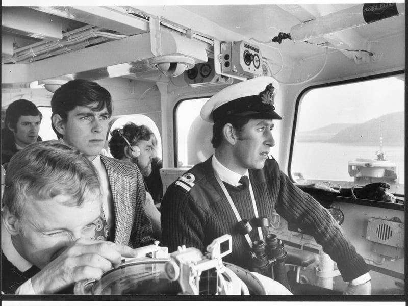 Prince Charles captains the HMS Bronington in Scottish waters as his brother Prince Andrew looks on.