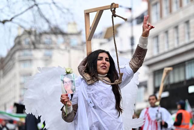A protester poses in mock gallows during a rally held in central London this month against the Iranian regime (Picture: Justin Tallis/AFP via Getty Images)
