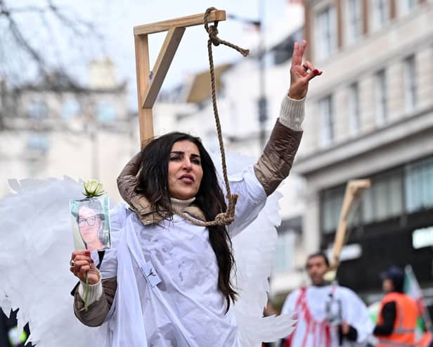 A protester poses in mock gallows during a rally held in central London this month against the Iranian regime (Picture: Justin Tallis/AFP via Getty Images)