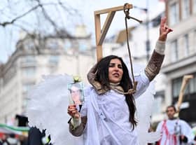 A protester poses in mock gallows during a rally held in central London this month against the Iranian regime (Picture: Justin Tallis/AFP via Getty Images)