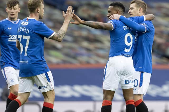 Rangers' Jermain Defoe (centre) celebrates making it 1-0 with Scott Arfield and Steven Davis during a Scottish Cup Third Round tie between Rangers and Cove Rangers at Ibrox Stadium, on April 04, 2021, in Glasgow, Scotland. (Photo by Alan Harvey / SNS Group)