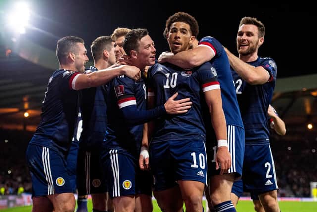 Scotland players celebrate with Che Adams after the Southampton striker made it 2-0. (Photo by Ross MacDonald / SNS Group)