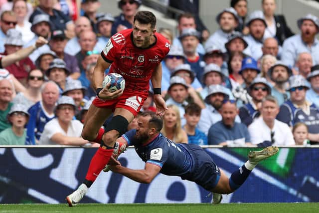 Toulouse's Scottish full-back Blair Kinghorn (L) is tackled by Leinster's Irish scrum-half Jamison Gibson-Park.