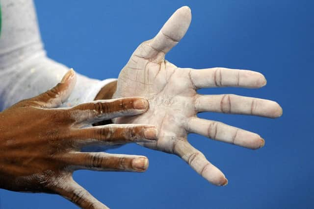 An athlete applies talcum powder during the women’s gymnastics at the Beijing 2008 Olympic Games (Photo: Franck Fife/AFP via Getty Images)