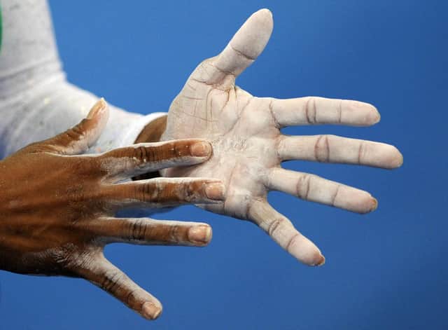 An athlete applies talcum powder during the women’s gymnastics at the Beijing 2008 Olympic Games (Photo: Franck Fife/AFP via Getty Images)