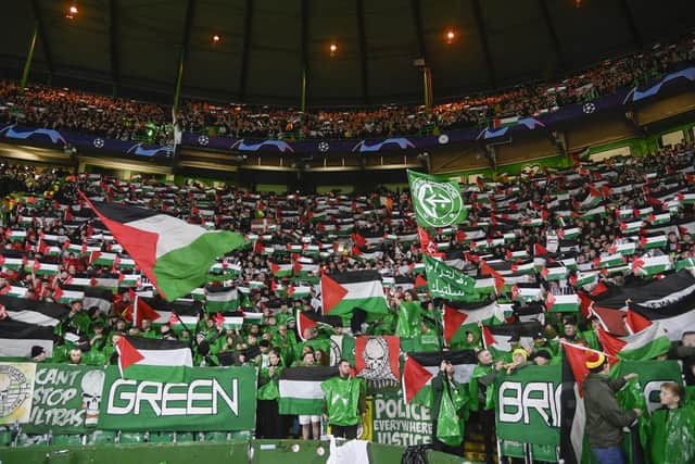 Celtic fan group, the Green Brigade, hold up Palestine flags during the UEFA Champions League match against Atletico Madrid. (Photo by Rob Casey / SNS Group)