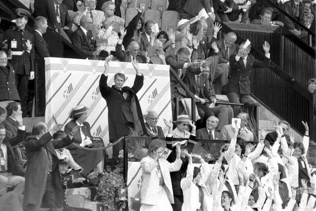 Prince Edward and some other VIPs join in the 'Mexican Wave' during the athletics at the Edinburgh Commonwealth Games 1986. The Queen remained seated.
