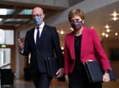 John Swinney, seen with Nicola Sturgeon, tests himself for Covid every time he leaves the house and is going to be in contact with other people (Picture: Russell Cheyne/pool/AFP via Getty Images)