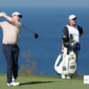 Bob MacIntyre tees off at the 13th hole watched by caddie Mike Burrow in the final round of The Sentry in Hawaii. Picture: Sarah Stier/Getty Images