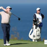 Bob MacIntyre tees off at the 13th hole watched by caddie Mike Burrow in the final round of The Sentry in Hawaii. Picture: Sarah Stier/Getty Images