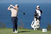 Bob MacIntyre tees off at the 13th hole watched by caddie Mike Burrow in the final round of The Sentry in Hawaii. Picture: Sarah Stier/Getty Images
