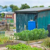 A garden shed with compost and water bins