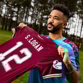 Shay Logan is uneveiled as a Hearts player after signing on loan from Aberdeen.