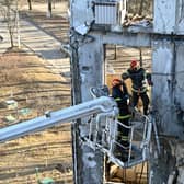 Workers attempt to make safe a residential building partially destroyed by shelling on the outskirts of Kharkiv, Ukraine (Picture: Sergey Bobok/AFP via Getty Images)