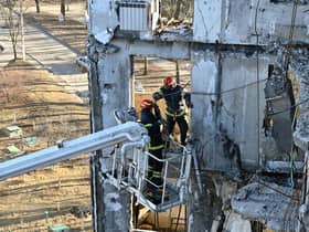 Workers attempt to make safe a residential building partially destroyed by shelling on the outskirts of Kharkiv, Ukraine (Picture: Sergey Bobok/AFP via Getty Images)