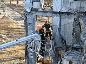 Workers attempt to make safe a residential building partially destroyed by shelling on the outskirts of Kharkiv, Ukraine (Picture: Sergey Bobok/AFP via Getty Images)
