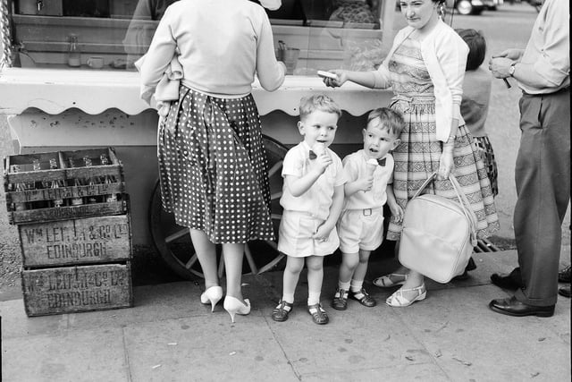 Youngsters Gordon Macpherson and Neill MacPherson eating ice cream at an ice cream van in Princes Street, Edinburgh,  during a heatwave in August 1961.
