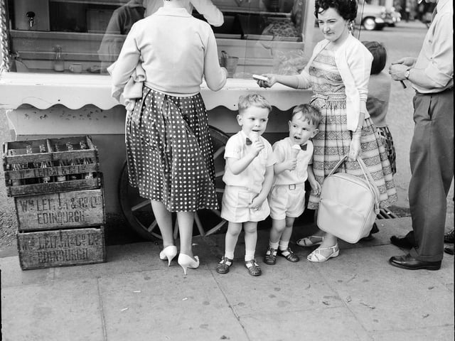 Youngsters Gordon Macpherson and Neill MacPherson eating ice cream at an ice cream van in Princes Street, Edinburgh,  during a heatwave in August 1961.