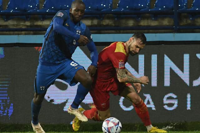 Finland's Glen Kamara (left) in action against Montenegro during this week's Nations League match. (Photo by SAVO PRELEVIC/AFP via Getty Images)