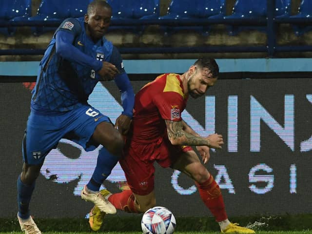 Finland's Glen Kamara (left) in action against Montenegro during this week's Nations League match. (Photo by SAVO PRELEVIC/AFP via Getty Images)