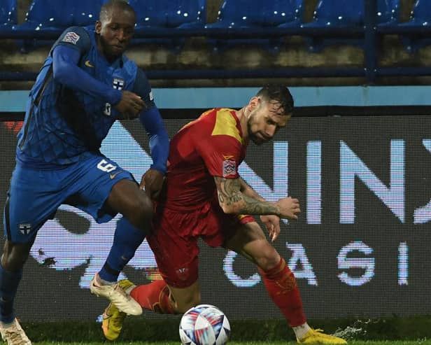 Finland's Glen Kamara (left) in action against Montenegro during this week's Nations League match. (Photo by SAVO PRELEVIC/AFP via Getty Images)