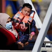 A distressed child is carried as a group of people thought to be migrants are brought in to Dover, Kent, from a Border Force Vessel, following a small boat incident in the Channel. Picture: Gareth Fuller/PA Wire
