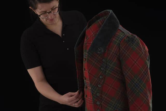 William Grant Foundation research fellow Rosie Waine with a 19th century tartan suit.