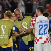 Croatia's Josip Juranovic consoles Japan forward, and Celtic team-mate, Daizen Maeda after the World Cup last 16 clash. (Photo by ANDREJ ISAKOVIC/AFP via Getty Images)