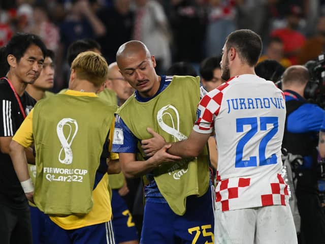 Croatia's Josip Juranovic consoles Japan forward, and Celtic team-mate, Daizen Maeda after the World Cup last 16 clash. (Photo by ANDREJ ISAKOVIC/AFP via Getty Images)