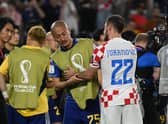Croatia's Josip Juranovic consoles Japan forward, and Celtic team-mate, Daizen Maeda after the World Cup last 16 clash. (Photo by ANDREJ ISAKOVIC/AFP via Getty Images)