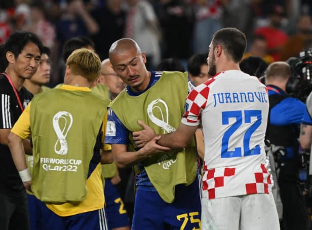 Croatia's Josip Juranovic consoles Japan forward, and Celtic team-mate, Daizen Maeda after the World Cup last 16 clash. (Photo by ANDREJ ISAKOVIC/AFP via Getty Images)