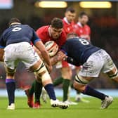 CARDIFF, WALES - FEBRUARY 12: Alex Cuthbert of Wales takes on Sam Skinner of Scotland and Matt Fagerson of Scotland during the Guinness Six Nations match between Wales and Scotland at Principality Stadium on February 12, 2022 in Cardiff, Wales. (Photo by Clive Mason/Getty Images)