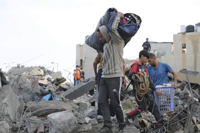 Palestinians salvage their belonging after an Israeli strike in Rafah yesterday. (Picture: AP Photo/Hatem Ali)