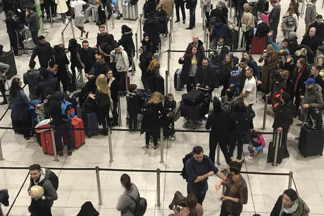 Passengers wait to check in at Gatwick Airport. Picture: Kirsty Wigglesworth