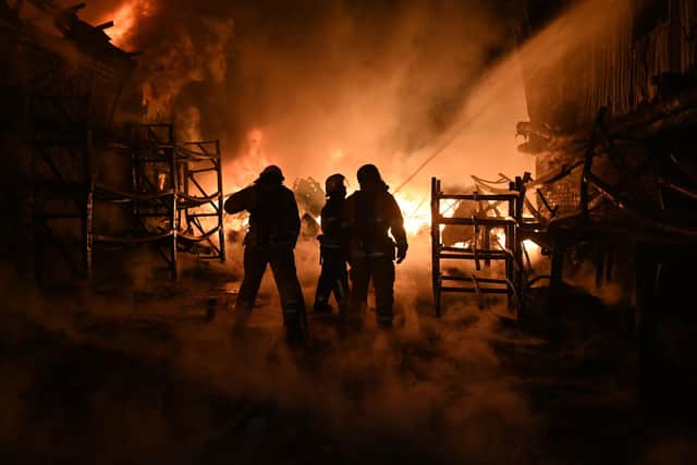 Ukrainian firefighters work to extinguish a fire at the site of a drone attack in Kharkiv earlier this month (Picture: Sergey Bobok/AFP via Getty Images)