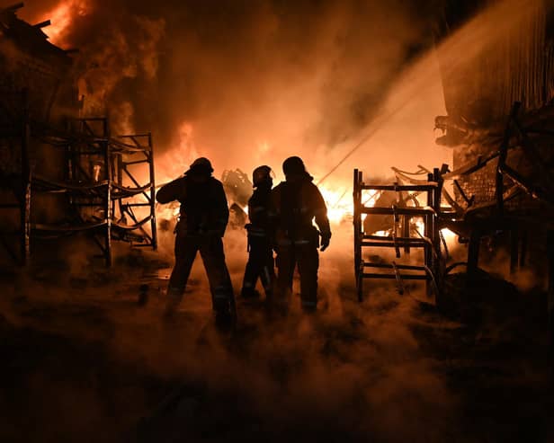 Ukrainian firefighters work to extinguish a fire at the site of a drone attack in Kharkiv earlier this month (Picture: Sergey Bobok/AFP via Getty Images)