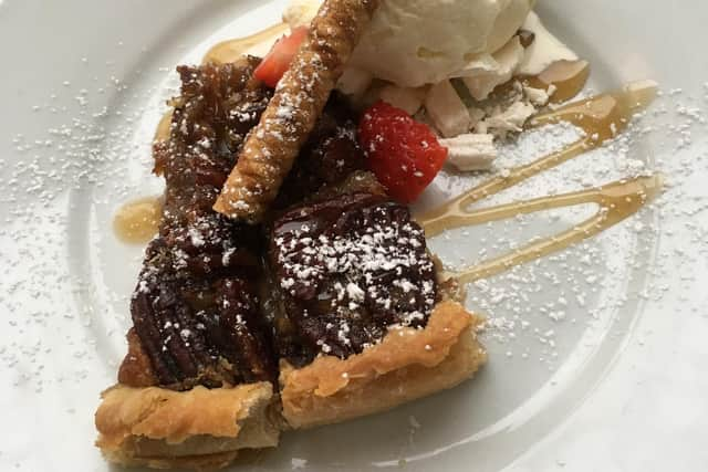 Pecan Flan, with strawberry, crumble of meringue, caramel sauce and Cream of Galloway ice cream at The Crown Hotel, Newton Stewart, Dumfries and Galloway.