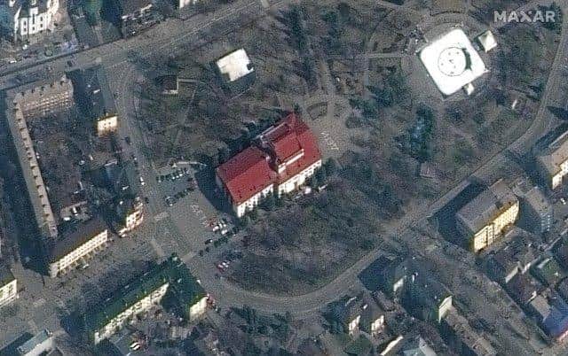 This satellite image provided by Maxar Technologies shows the Mariupol Drama Theater in Mariupol, Ukraine on Monday, March 14, 2022. Ukrainian officials say Russian forces destroyed the theatre in the city of Mariupol where hundreds of people were sheltering.The Maxar satellite imagery firm said images from Monday showed the word children had been written in large white letters in Russian in front of and behind the building. (Maxar Technologies via AP)