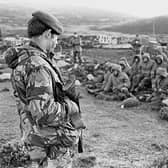 Argentinian soldiers captured at Goose Green on the Falkland Islands are guarded by a Royal Marine (Picture: PA)