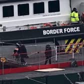 Migrants are escorted ashore from the UK Border Force vessel 'BF Ranger' in Dover, southeast England.