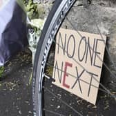 E for Enough: A sign left among flowers for cyclist James Harrison who died in a collision with a van (Picture: Lisa Ferguson)