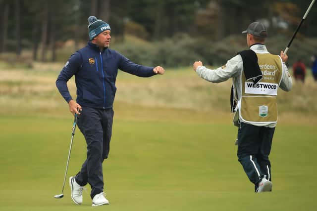 Leader Lee Westwood fist pumps his son and caddie Sam on the 18th green after his first round of the Aberdeen Standard Investments Scottish Open at The Renaissance Club. Picture: Andrew Redington/Getty Images