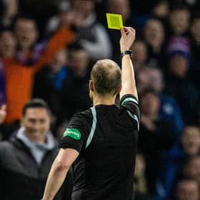 Willie Collum gives Ayr manager Scott Brown a yellow card during the Scottish Cup clash with Rangers.