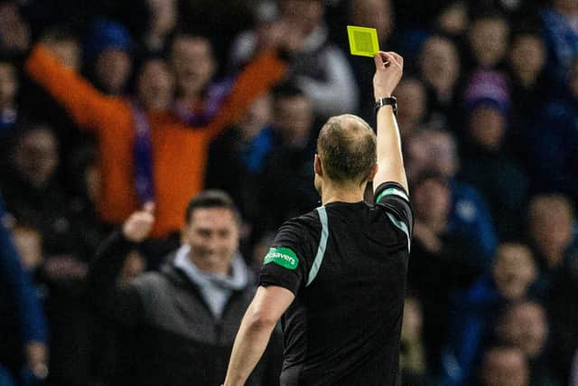 Willie Collum gives Ayr manager Scott Brown a yellow card during the Scottish Cup clash with Rangers.