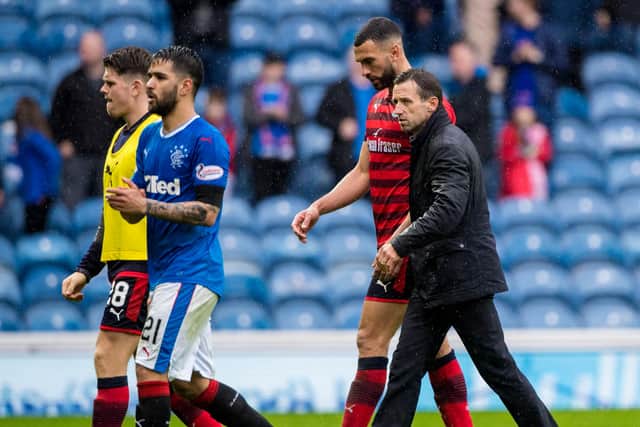 Steven Caulker walks off the pitch at Ibrox with manager Neil McCann after skippering Dundee in a 4-0 defeat against Rangers